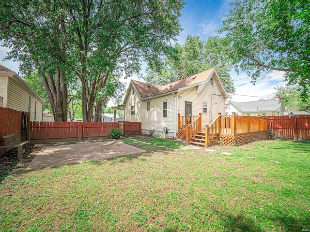 back of house featuring a patio area and a deck