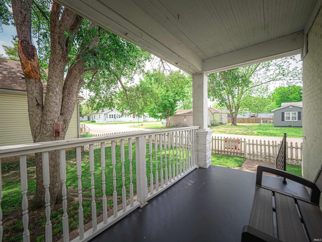 balcony featuring covered porch and a residential view