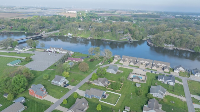 aerial view of property and surrounding area with a large body of water and nearby suburban area