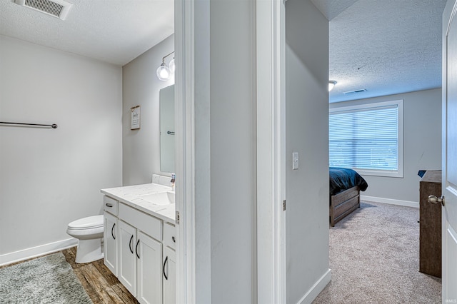 5783 Brookstone Dr, Newburgh, IN 47630 - bathroom with a textured ceiling, vanity, toilet, and baseboards