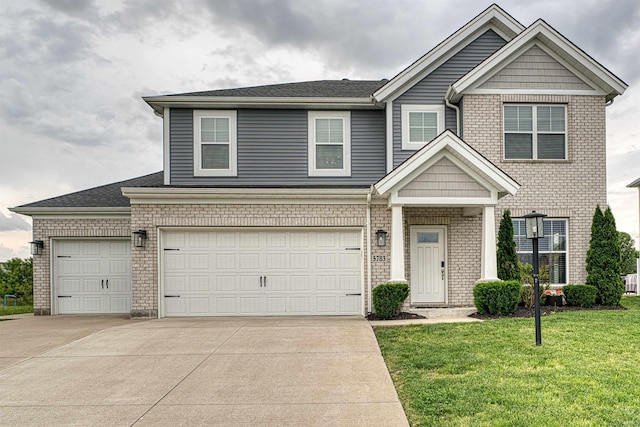 5783 Brookstone Dr, Newburgh, IN 47630 - view of front facade with concrete driveway, brick siding, a front lawn, and an attached garage