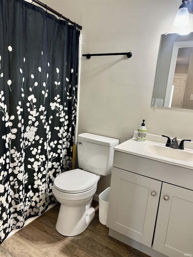 1719 Linwood Dr, Bedford, IN 47421 - full bath with wood finished floors, toilet, vanity, and a shower with curtain