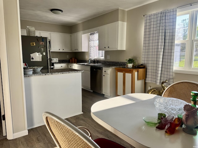 1719 Linwood Dr, Bedford, IN 47421 - kitchen featuring stainless steel appliances, white cabinets, a sink, dark wood finished floors, and dark stone counters