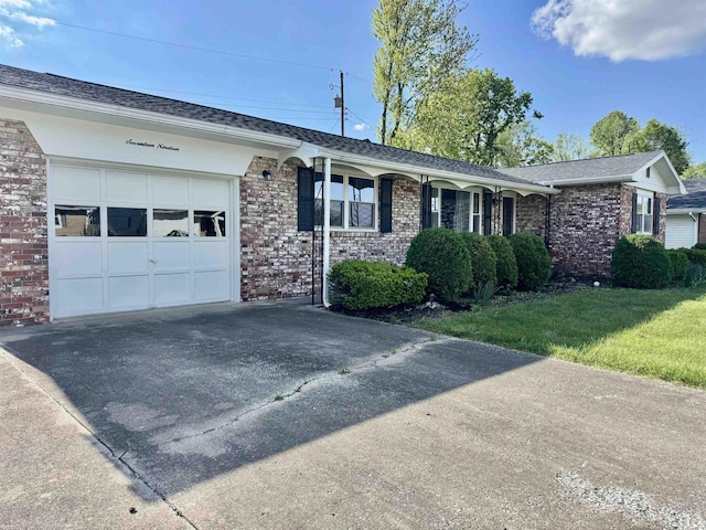 1719 Linwood Dr, Bedford, IN 47421 - ranch-style house with concrete driveway, a garage, brick siding, and a front lawn