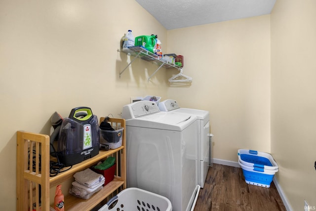 clothes washing area featuring independent washer and dryer, wood finished floors, baseboards, and a textured ceiling