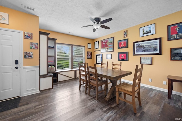 dining area with ceiling fan, dark wood-style flooring, a textured ceiling, and baseboards