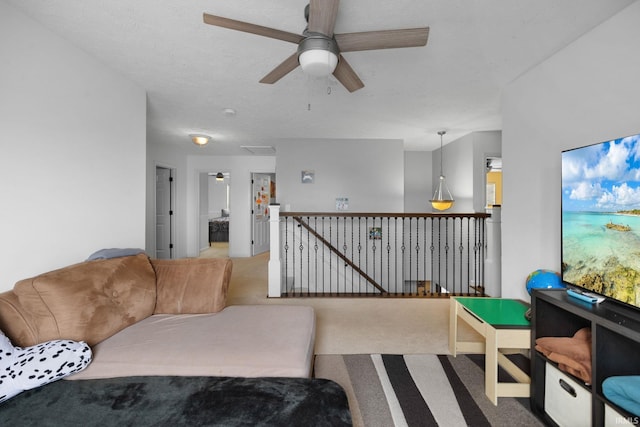 living area with a ceiling fan and carpet flooring