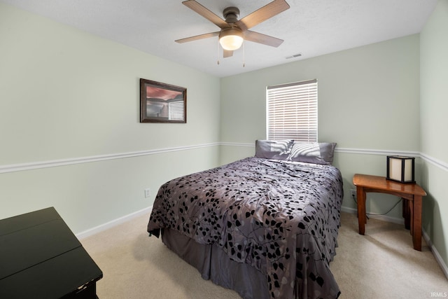 carpeted bedroom featuring baseboards and ceiling fan