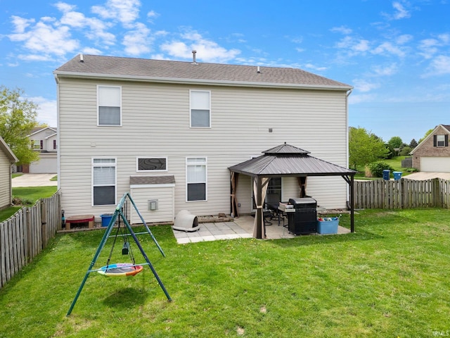 rear view of property with a gazebo and a patio area