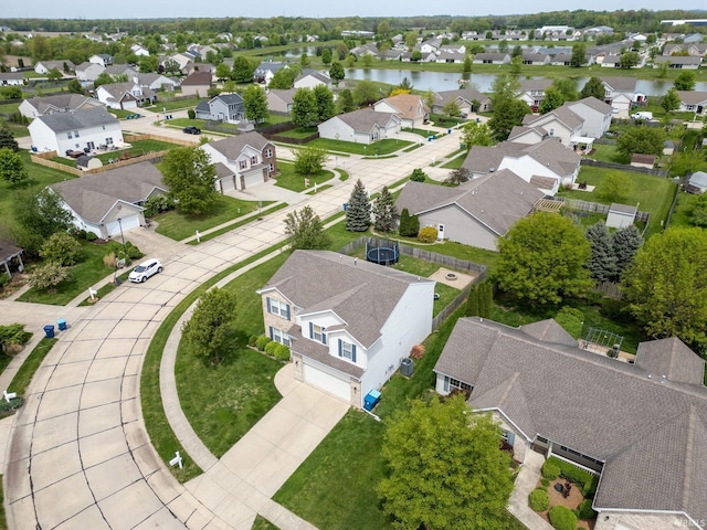 aerial view of residential area featuring a large body of water