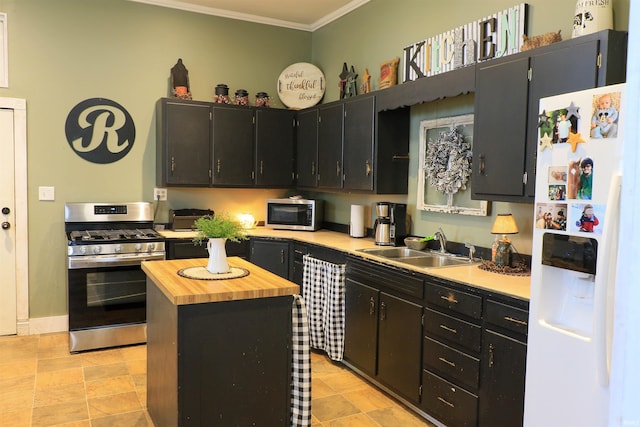 1008 E Walnut St, Petersburg, IN 47567 - kitchen featuring appliances with stainless steel finishes, ornamental molding, butcher block countertops, a sink, and dark cabinetry