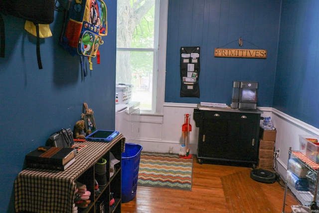 1008 E Walnut St, Petersburg, IN 47567 - doorway to outside featuring wood finished floors and a wainscoted wall