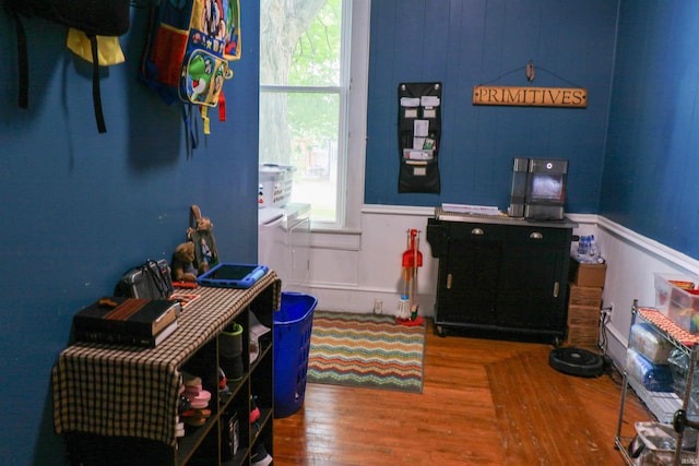 1008 E Walnut St, Petersburg, IN 47567 - rec room with wood finished floors, plenty of natural light, and a wainscoted wall
