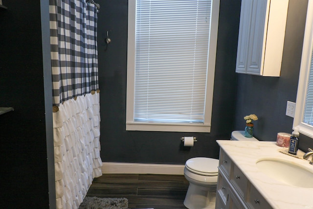 1008 E Walnut St, Petersburg, IN 47567 - full bathroom featuring baseboards, toilet, wood finished floors, vanity, and a shower with curtain