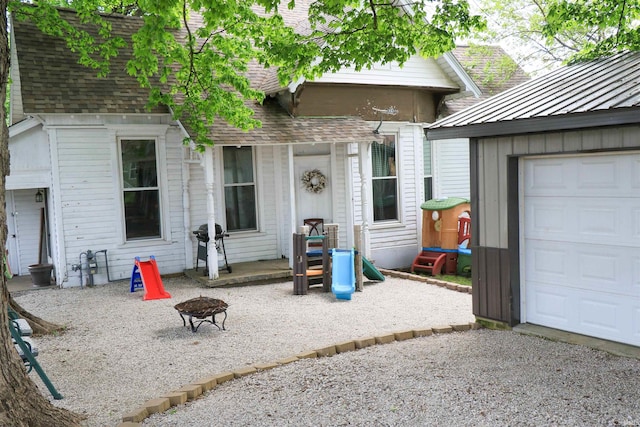 1008 E Walnut St, Petersburg, IN 47567 - entrance to property featuring a shingled roof and a garage