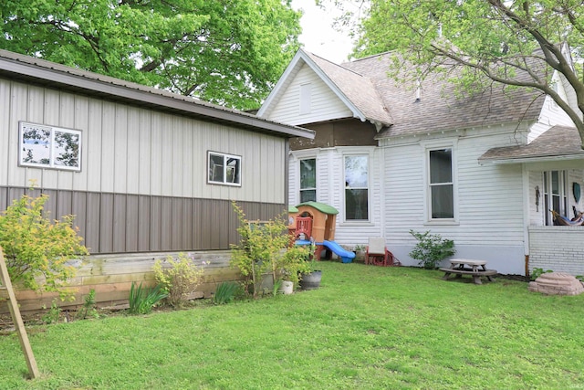1008 E Walnut St, Petersburg, IN 47567 - rear view of house with a yard and board and batten siding