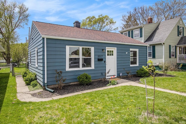 2017 Delaware St, Mishawaka, IN 46544 - view of front of property featuring a chimney, a gate, and roof with shingles