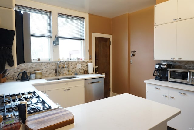 1208 Leeper Ave, South Bend, IN 46617 - kitchen with a sink, dishwasher, backsplash, light countertops, and white cabinets
