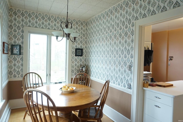 1208 Leeper Ave, South Bend, IN 46617 - dining area with wallpapered walls, baseboard heating, light wood-type flooring, baseboards, and a chandelier