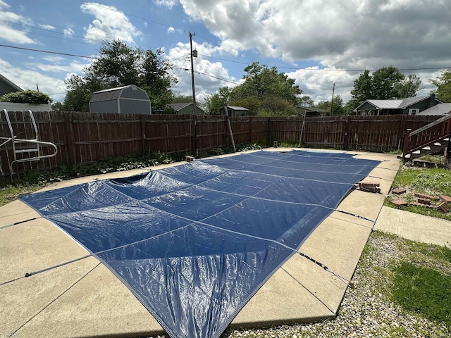 view of pool with a fenced backyard and a patio area