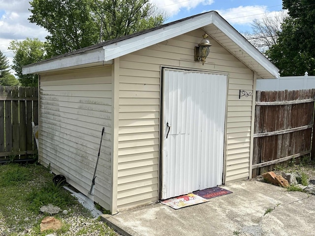 view of shed featuring fence