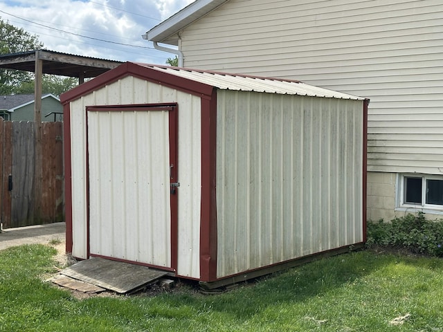 view of shed featuring fence
