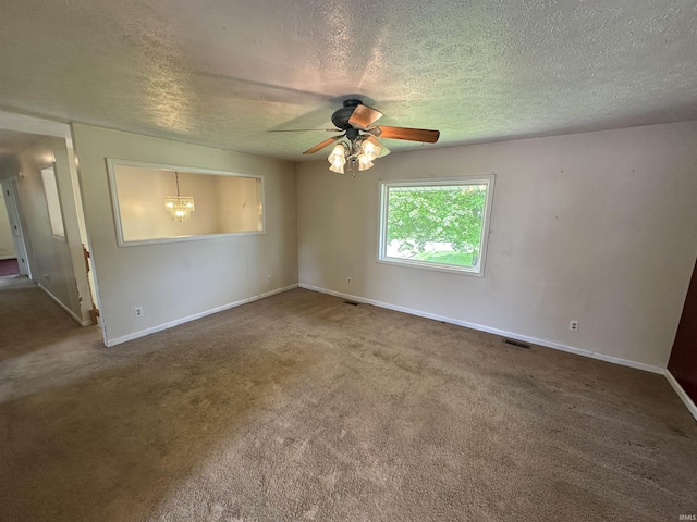 unfurnished room with a ceiling fan, baseboards, a textured ceiling, carpet, and a chandelier