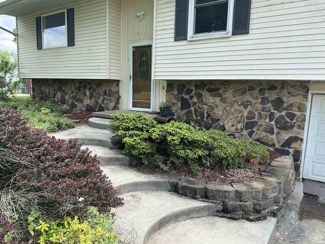 doorway to property with stone siding