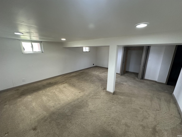below grade area with carpet floors, recessed lighting, and baseboards