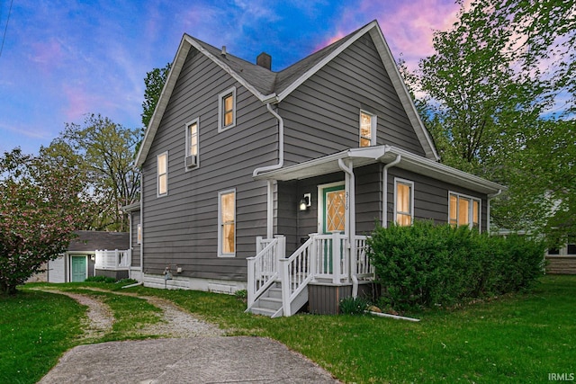 view of front of home featuring a front lawn and a chimney