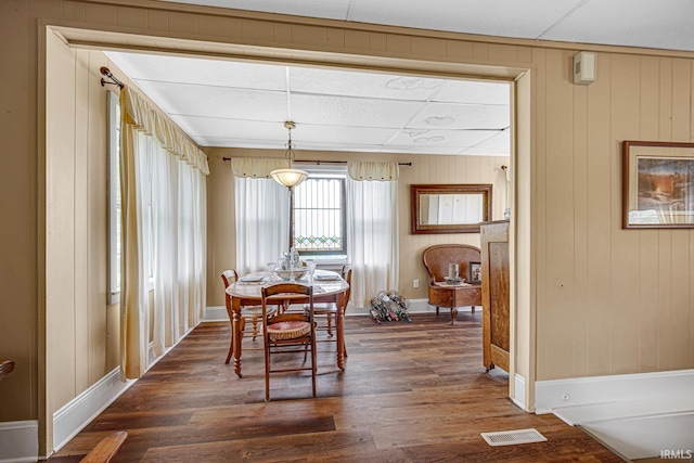 dining room featuring dark wood-style floors and baseboards