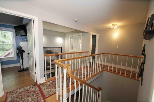 8209 Berry Dr, Evansville, IN 47710 - hallway with an upstairs landing, wood finished floors, and baseboards