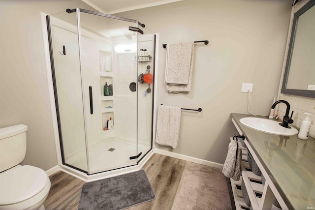 8209 Berry Dr, Evansville, IN 47710 - full bathroom featuring toilet, wood finished floors, a stall shower, baseboards, and vanity