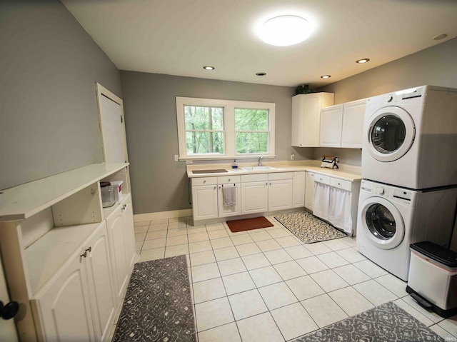 8209 Berry Dr, Evansville, IN 47710 - washroom with stacked washing machine and dryer, cabinet space, light tile patterned floors, and recessed lighting