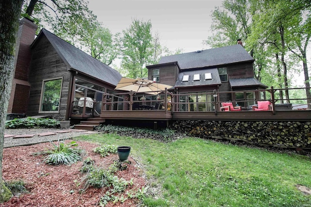 8209 Berry Dr, Evansville, IN 47710 - rear view of property featuring a deck, a chimney, a shingled roof, and a lawn