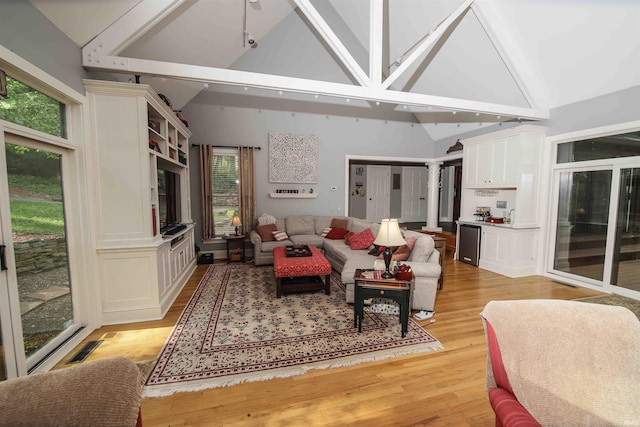 8209 Berry Dr, Evansville, IN 47710 - living area featuring healthy amount of natural light, light wood finished floors, and high vaulted ceiling