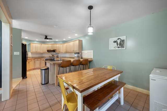dining space with light tile patterned floors, recessed lighting, a ceiling fan, and baseboards