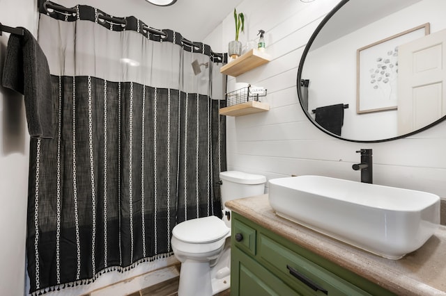 bathroom featuring toilet, vanity, a shower with shower curtain, and wood walls
