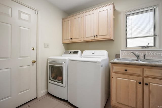 washroom with independent washer and dryer, cabinet space, and light tile patterned floors