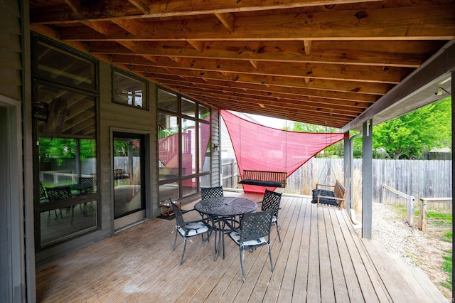 deck featuring fence and outdoor dining space