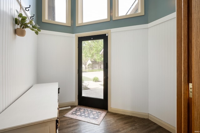 entryway featuring dark wood finished floors and a wainscoted wall
