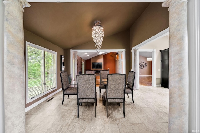 51167 Huntington Ln, Granger, IN 46530 - dining room featuring decorative columns, lofted ceiling, a chandelier, and baseboards