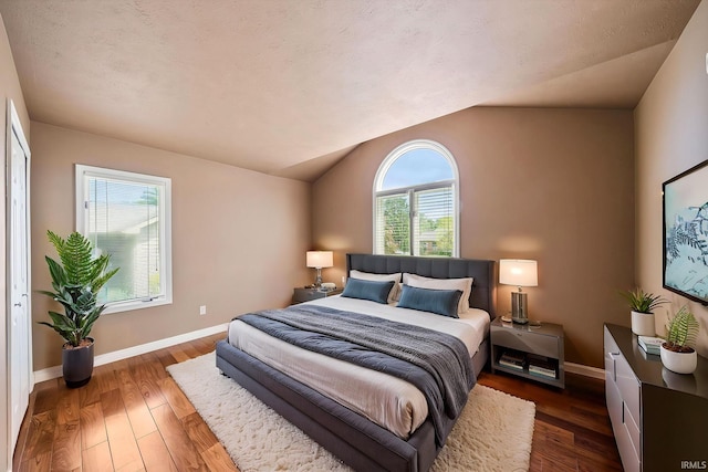 51167 Huntington Ln, Granger, IN 46530 - bedroom with hardwood / wood-style flooring, baseboards, and vaulted ceiling