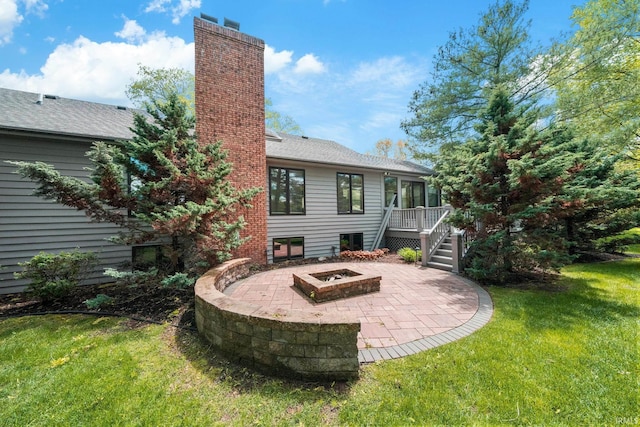 51167 Huntington Ln, Granger, IN 46530 - back of property featuring an outdoor fire pit, a patio area, a chimney, a yard, and a deck