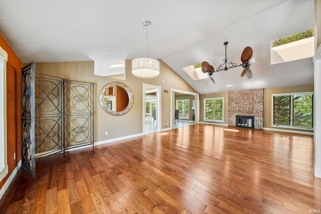 51167 Huntington Ln, Granger, IN 46530 - unfurnished living room with a skylight, healthy amount of natural light, wood finished floors, lofted ceiling, and a ceiling fan