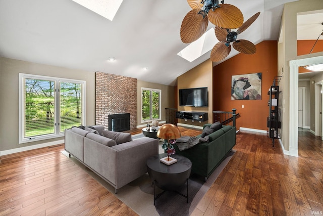 51167 Huntington Ln, Granger, IN 46530 - living area featuring a skylight, vaulted ceiling, hardwood / wood-style flooring, and baseboards