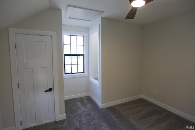 bonus room with attic access, dark colored carpet, baseboards, and ceiling fan