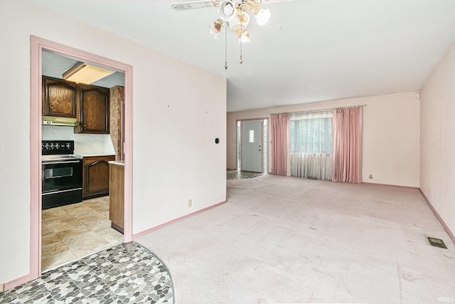 unfurnished living room featuring a ceiling fan, light carpet, and baseboards
