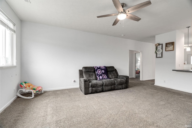unfurnished room with a ceiling fan, carpet floors, and baseboards