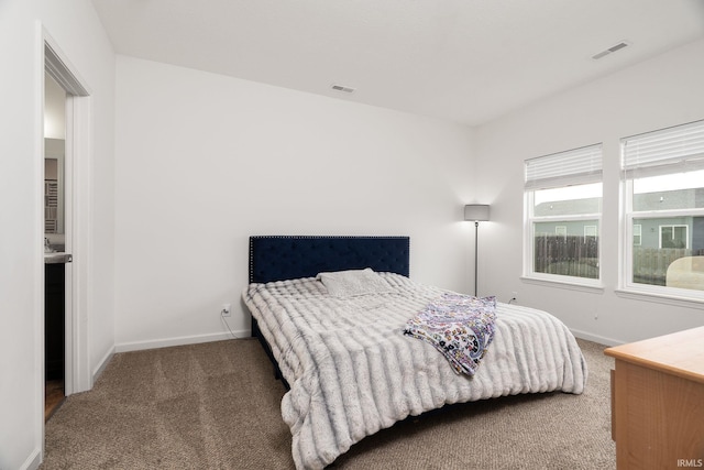 bedroom featuring carpet floors and baseboards